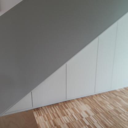 Schrank unter der Dachschräge Weißer Einbauschrank nutzt den Raum unter einer Dachschräge bis zum Boden passgenau aus.